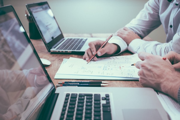 Paperwork and notes spread across a desk during a financing conversation