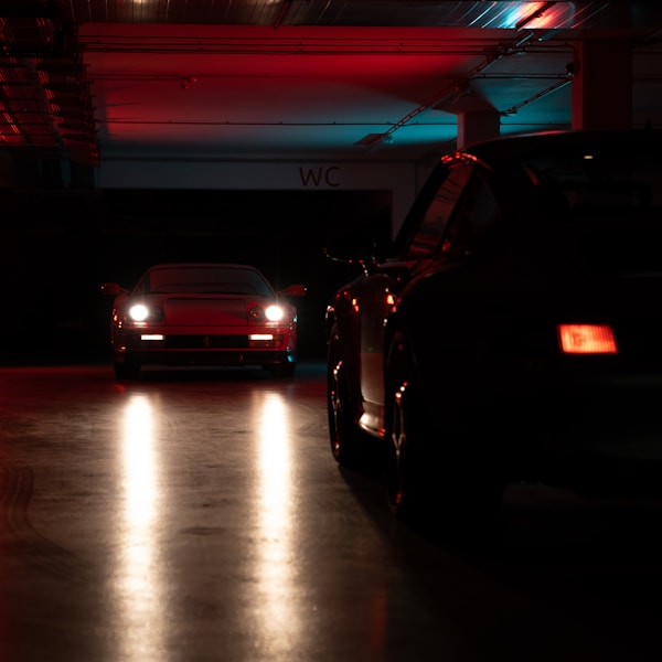 Front view of a parked sports car under garage lighting